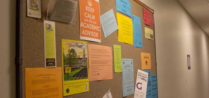 colorful fliers on a bulletin board