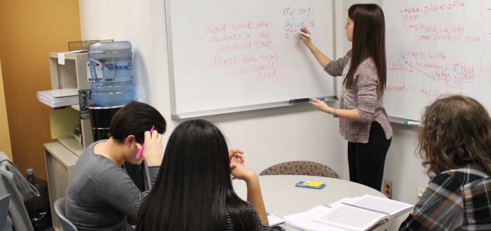 A tutor teaches three tutees at Rowan Tutoring Center