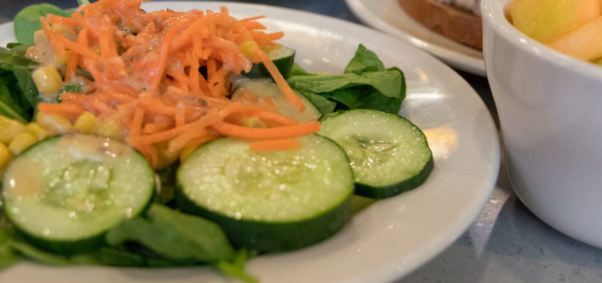 cucumbers, shredded carrots on a salad on a white plate