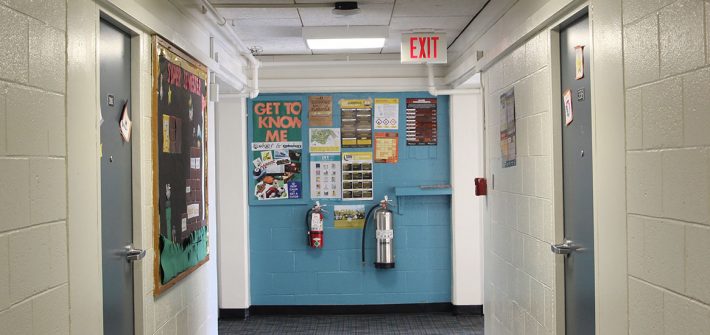 The hallway of Mullica and a brightly colored bulletin board.