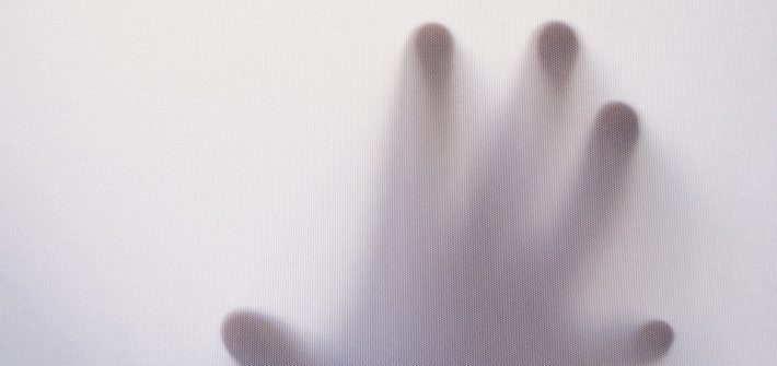 spooky hand reaches out through a white mist