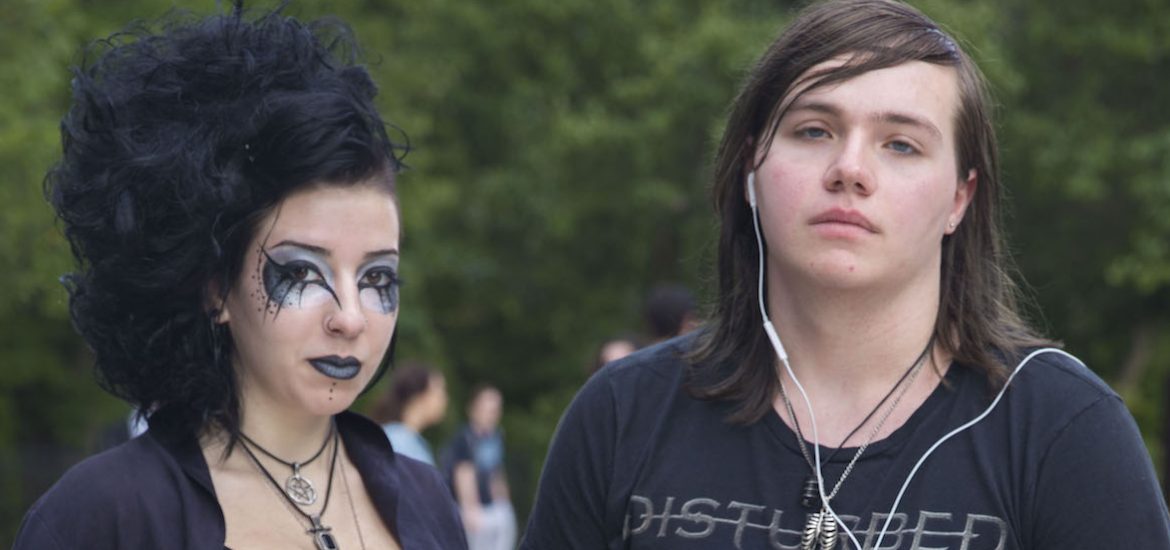 Concetta Davis (left), dressed in goth style with all black clothing and eye makeup stands next to her friend wearing a Disturbed shirt.