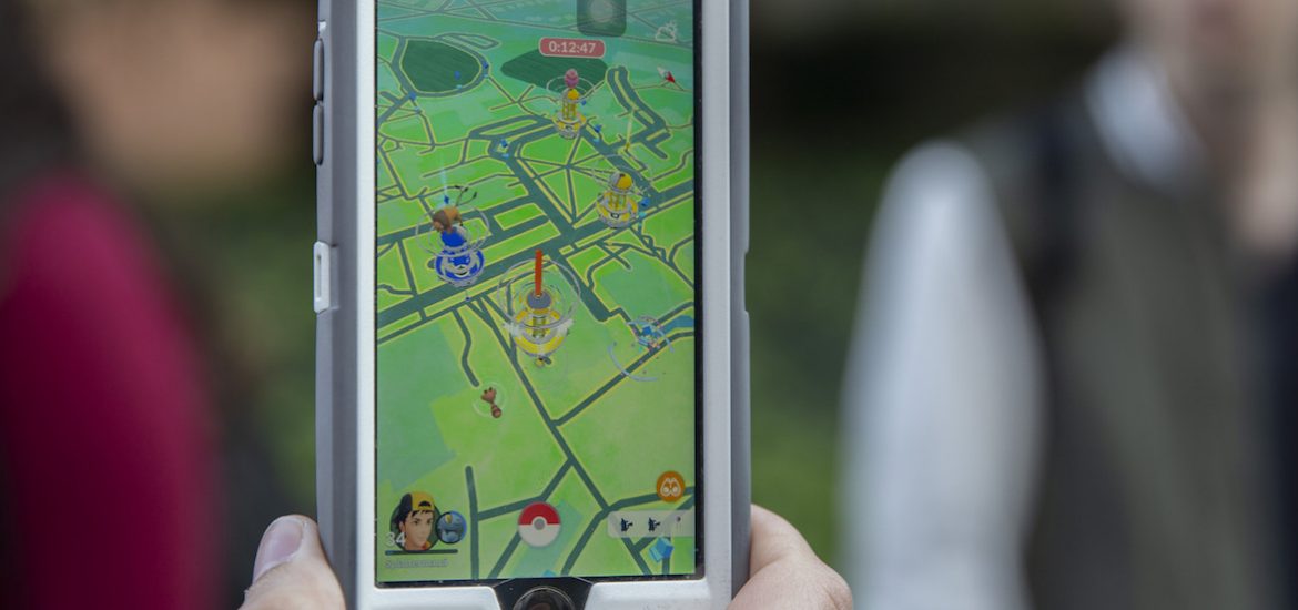 a close-up of a student holding a phone with the pokemon go app open.