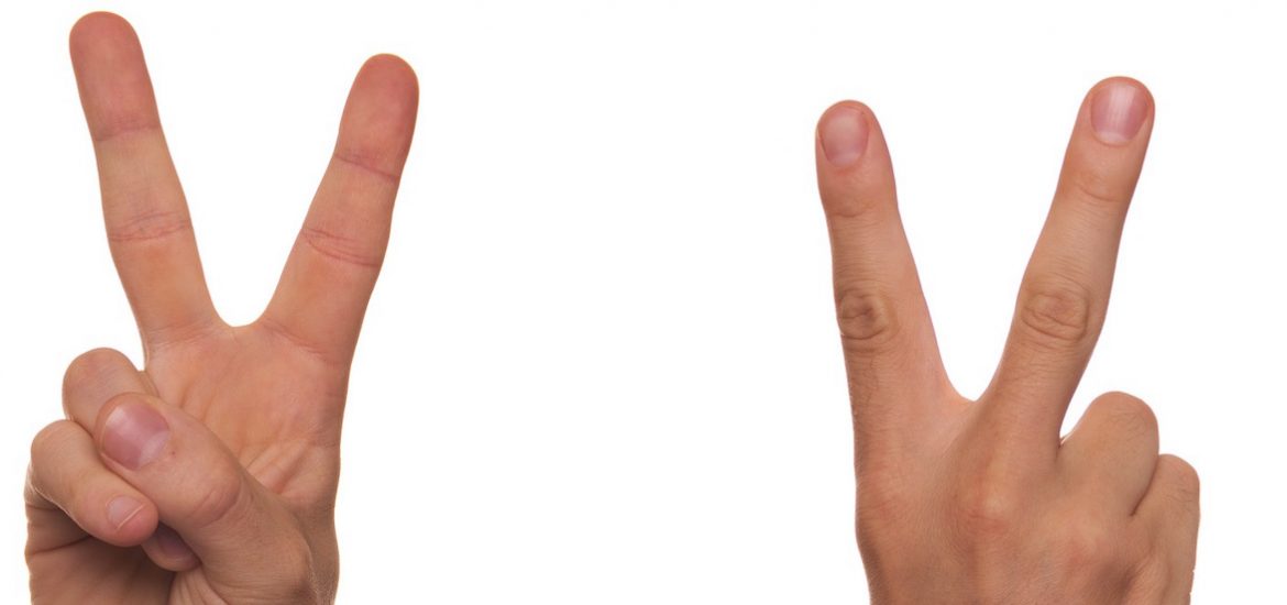 close up of fingers making peace sign with two hands
