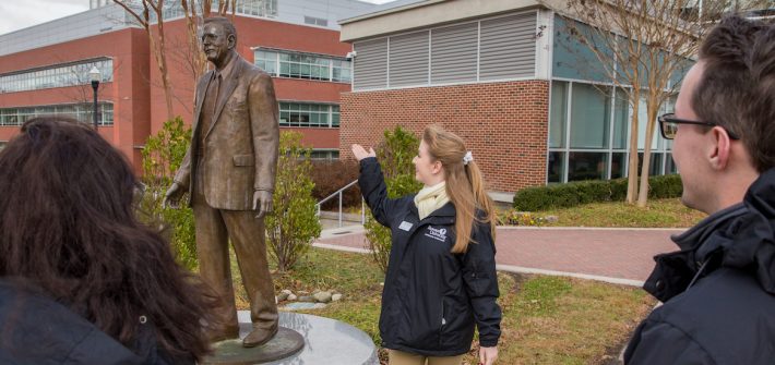 Grace gives new students a tour of Rowan starting with the Henry Rowan Statue