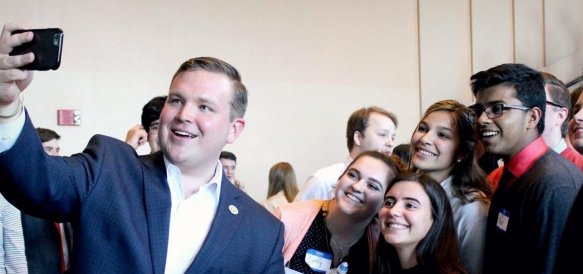 Rowan University alumnus Bill Moen taking a selfie with supporters at a political event.