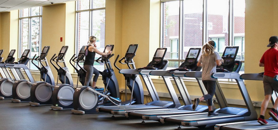 Several students working out on treadmills in a fitness center