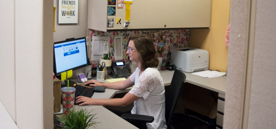 Rowan admissions officer Amanda Kuster working at her desk in Savitz Hall