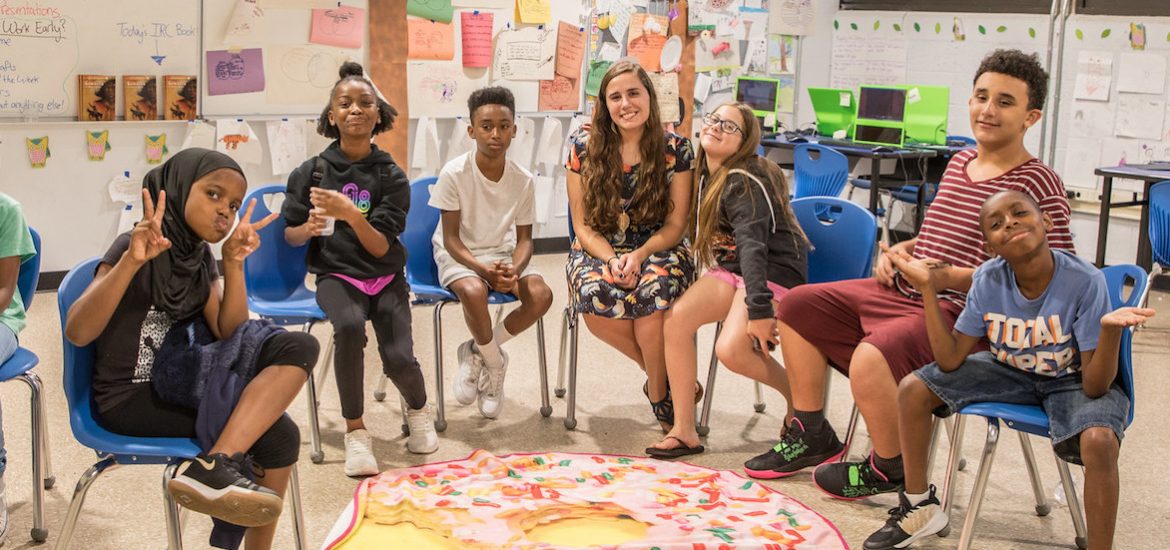 Kasey DiSessa of Rowan University sits in the middle of a row of middle school students she teaches