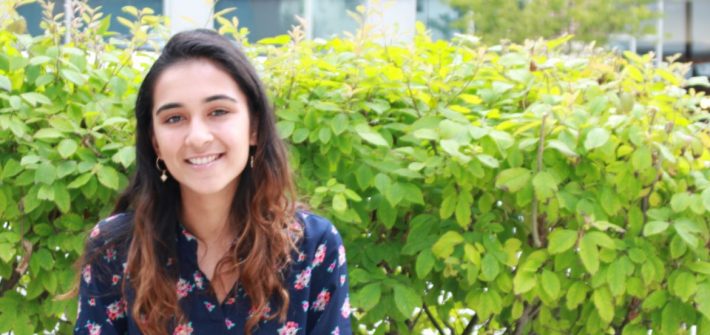 Molecular and cellular biology major Amaal Khan sits outside on a bench
