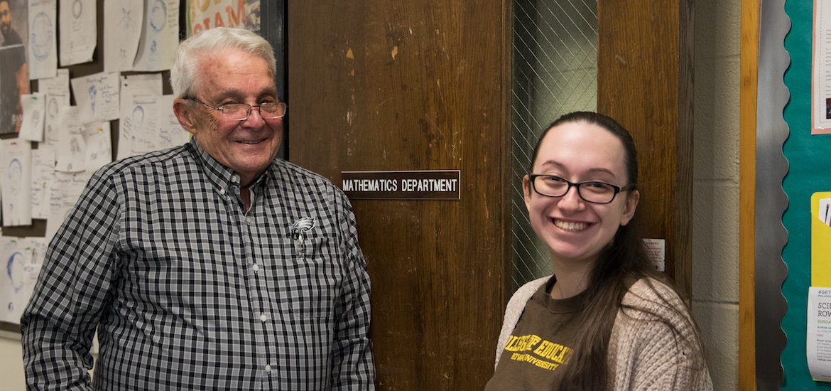 Adriana and Professor Smith smile in front of the Mathematics suite.