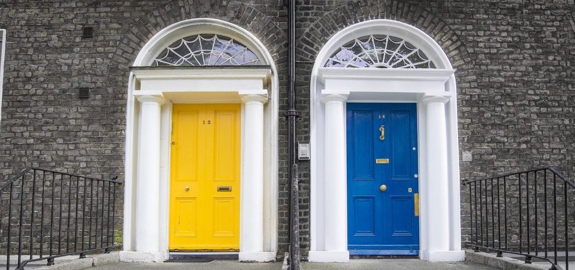 Stock image of a yellow door and a blue door side by side.