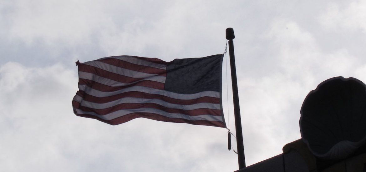 An American flag flying in the wind.