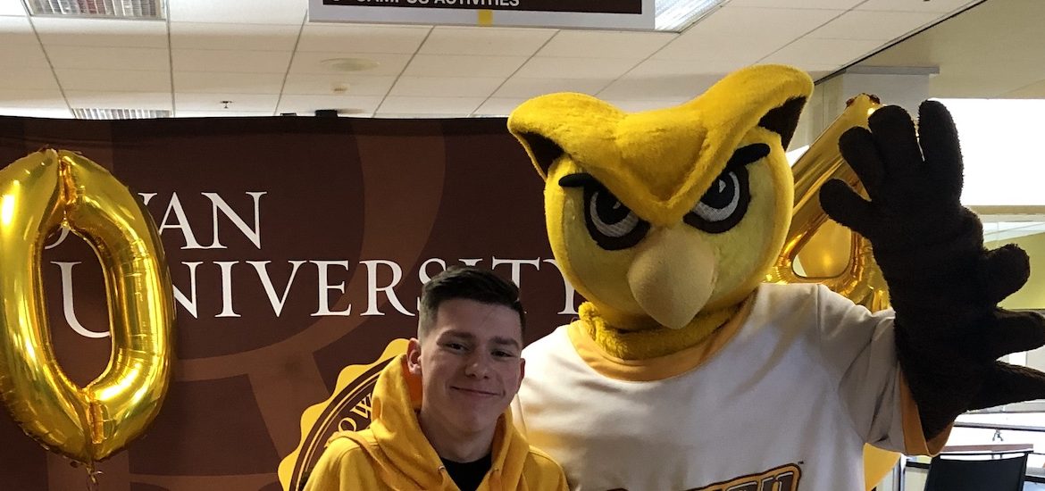 Logan poses with Rowan University's mascot.