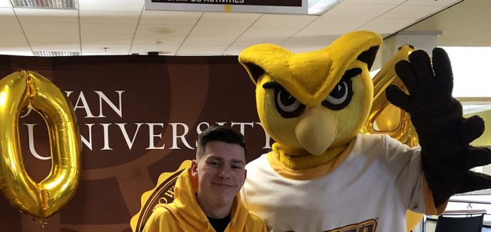 Logan poses with Rowan University's mascot.