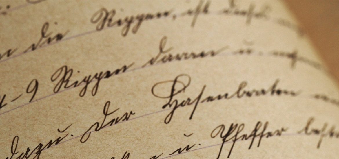 Stock image of black ink cursive on tepia colored paper.