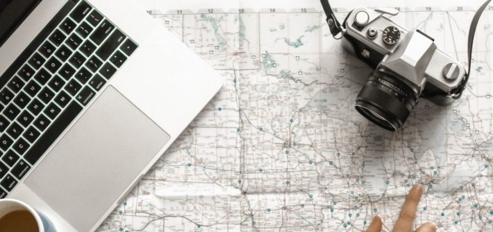 stock image of a laptop, map and a camera