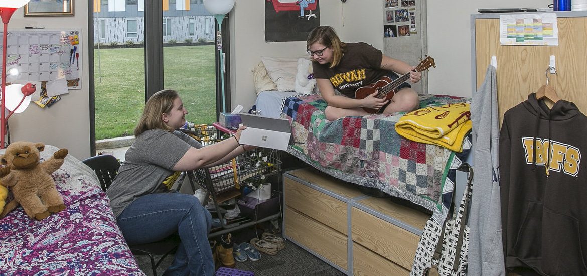 Two roommates hanging out in their dorm.