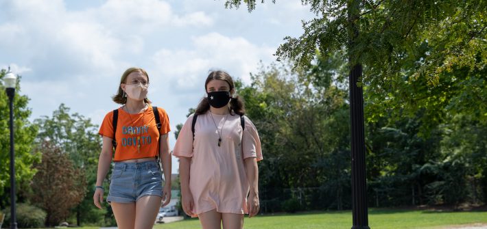 Sammy and Vicky walk together on campus.