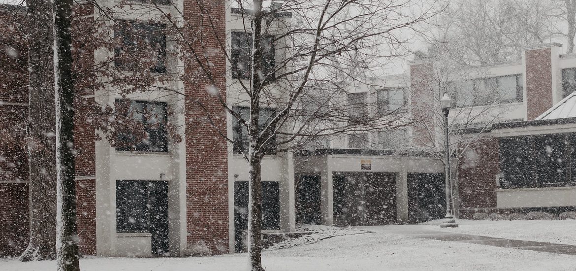 Exterior shot of falling snow outside a residence hall.