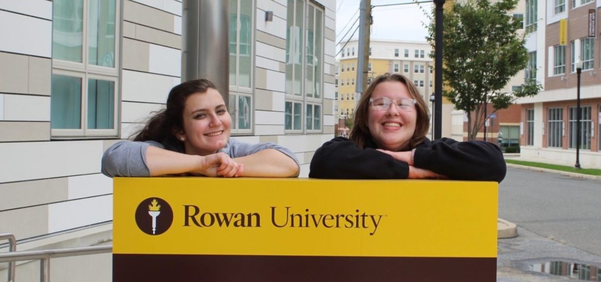 Two Rowan students stand in front of 301 High St.