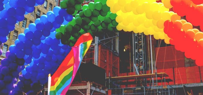 Balloon arch and flag at pride parade