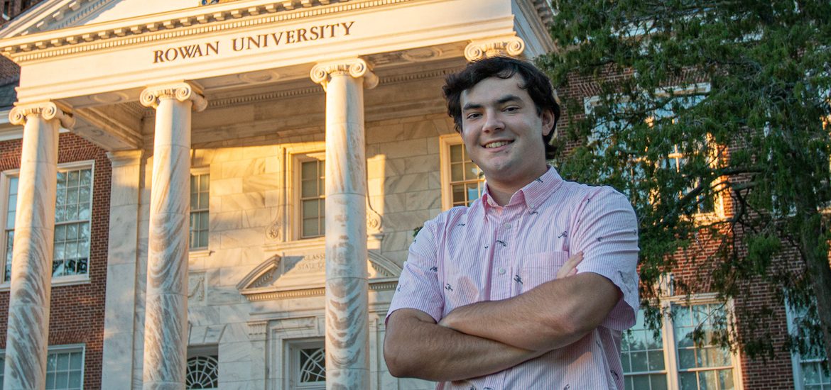 Nick smiles, stands in front of Bunce Hall.