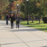 Rowan University students walk on campus on a fall day.