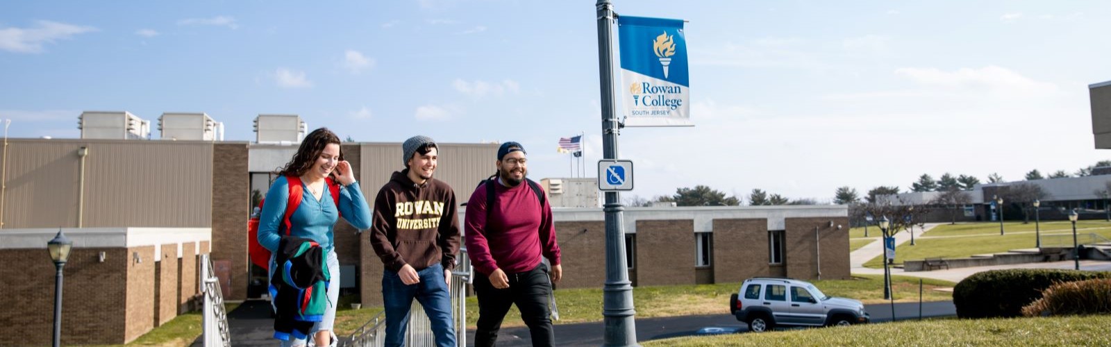 Three students walking around Rowan College of South Jersey campus.